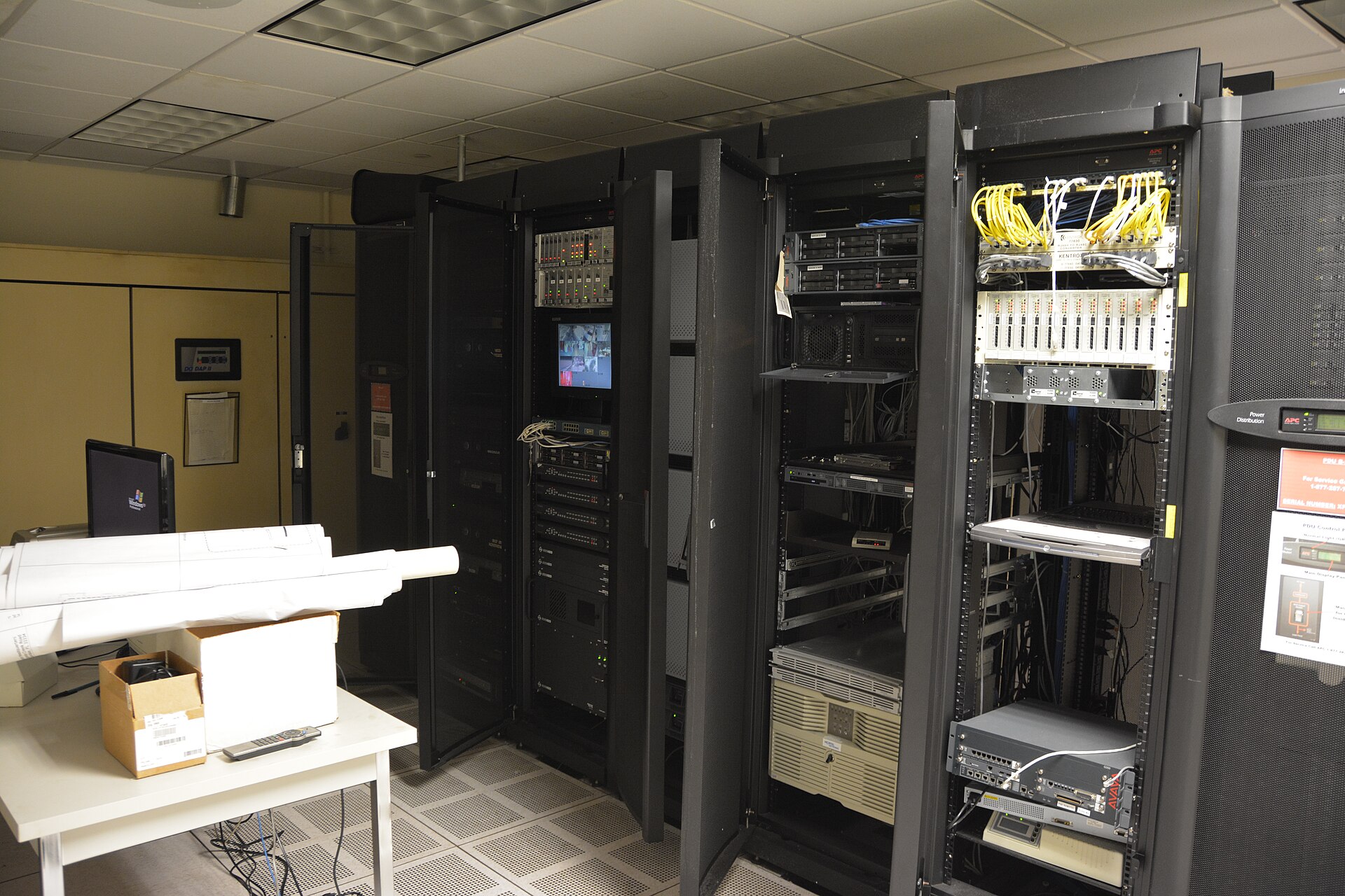 Rows of lit server racks in a dense data-center aisle